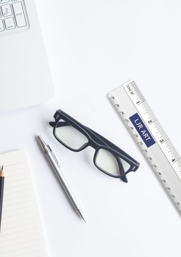 White desk office with laptop, smartphone and other work supplies with cup of coffee. Top view with copy space for input the text. Designer workspace on desk table essential elements on flat lay.